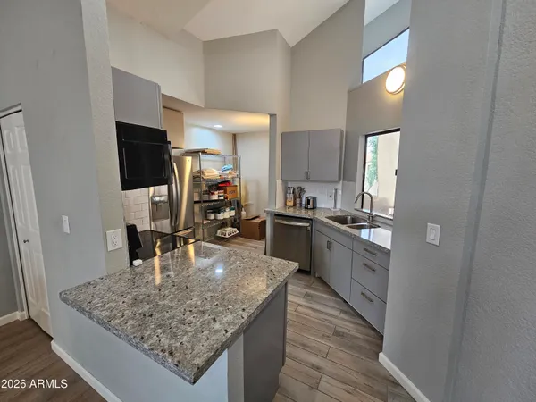 a kitchen with a sink refrigerator and cabinets
