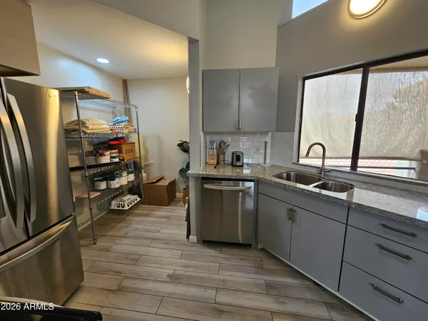 a kitchen with granite countertop a refrigerator stove and microwave