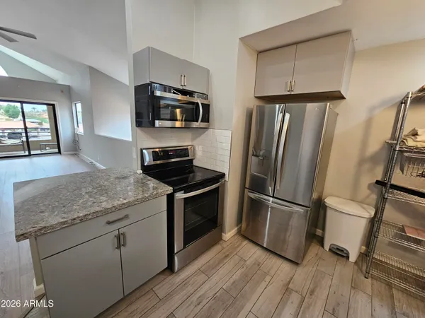 a kitchen with sink cabinets and appliances