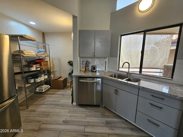 a view of a kitchen with wooden floor