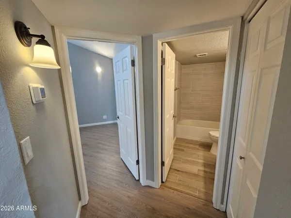 a view of an empty room with wooden floor