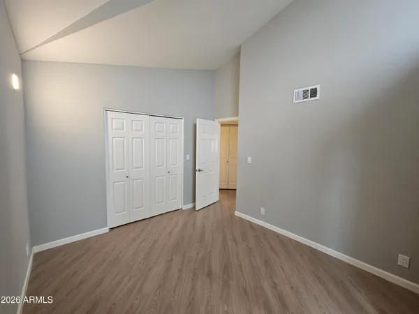 a view of an empty room with wooden floor