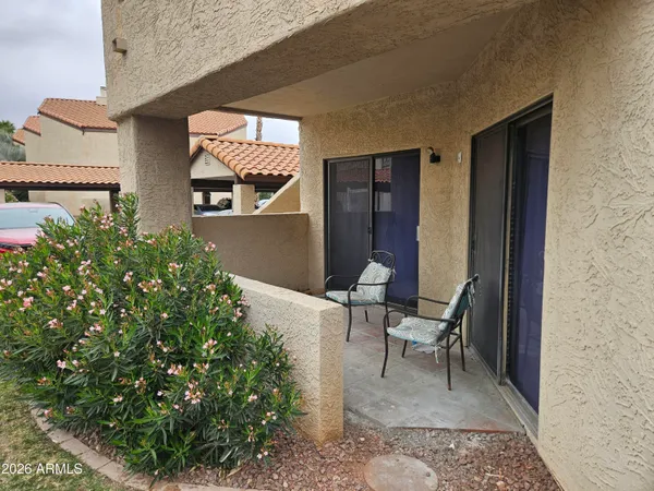 a view of a chair and table in the balcony