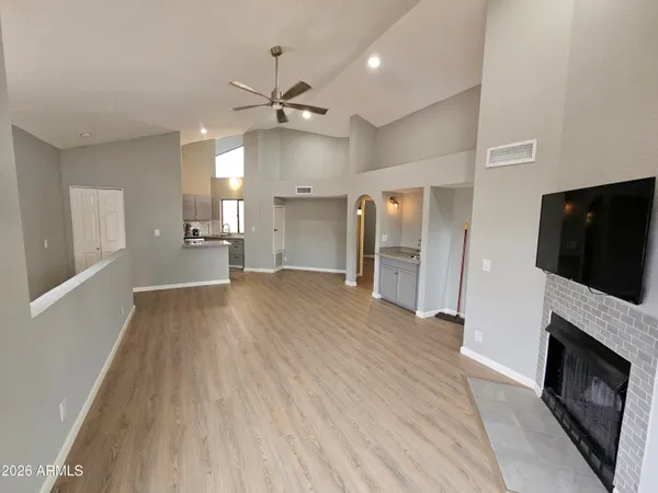 a view of a livingroom with a fireplace wooden floor and staircase