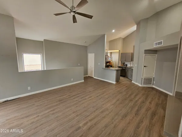 a view of a kitchen with a sink and a refrigerator
