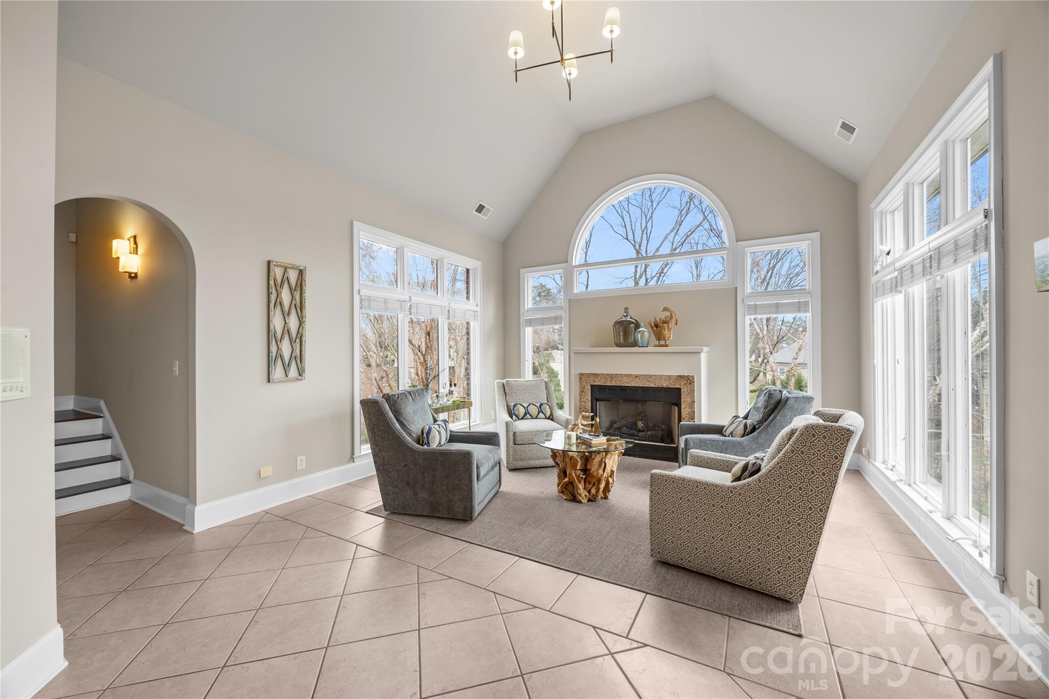 8052 Westbay Road Denver, NC 28037 - Photo 16 of 45 a living room with furniture a fireplace and a chandelier