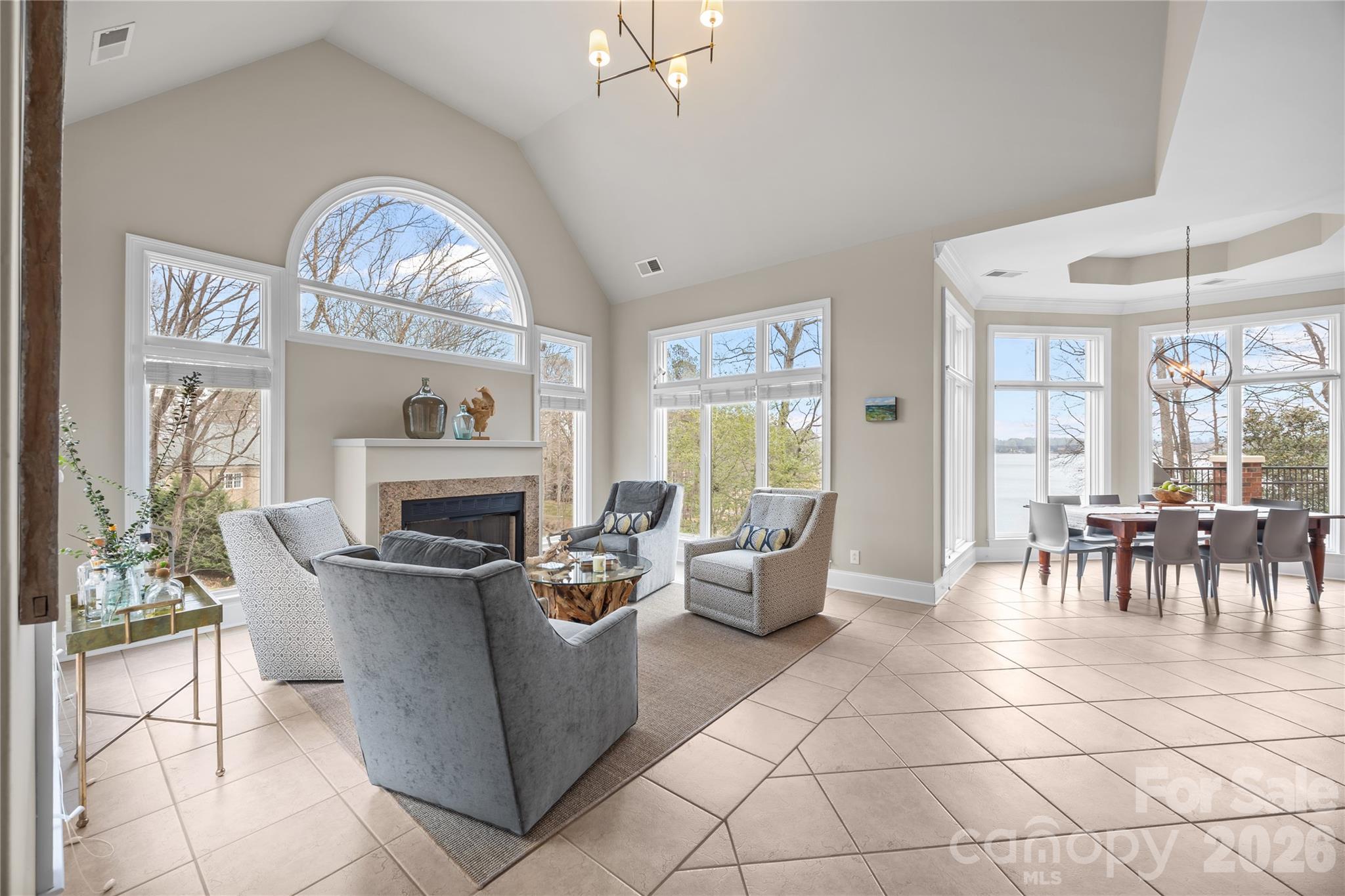 8052 Westbay Road Denver, NC 28037 - Photo 17 of 45 a living room with furniture a fireplace and a table