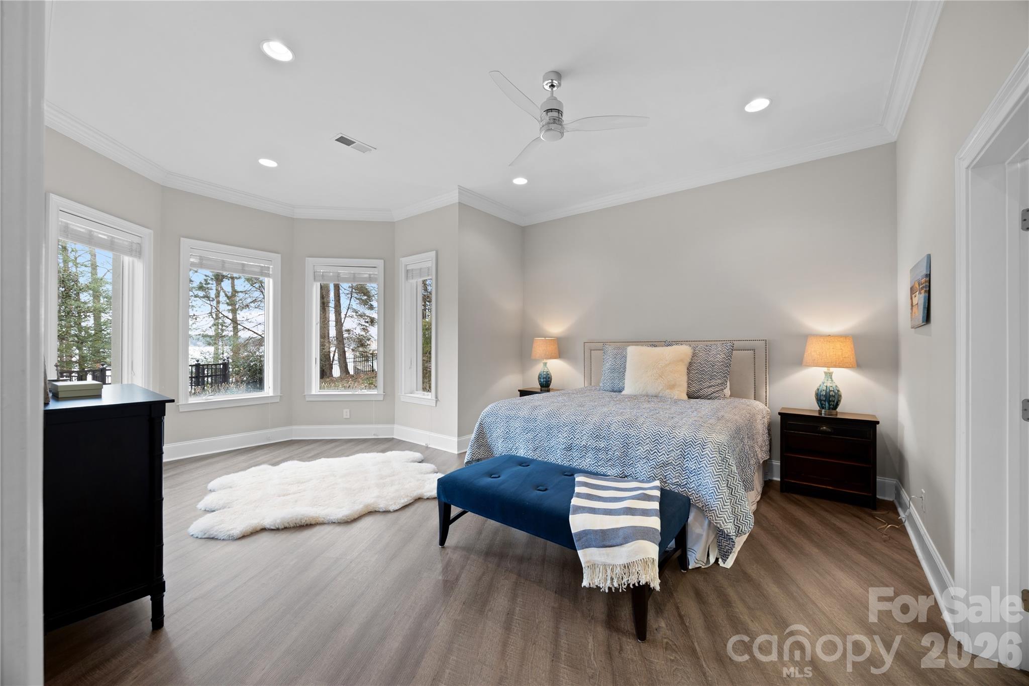 8052 Westbay Road Denver, NC 28037 - Photo 32 of 45 a spacious bedroom with a bed and wooden floor