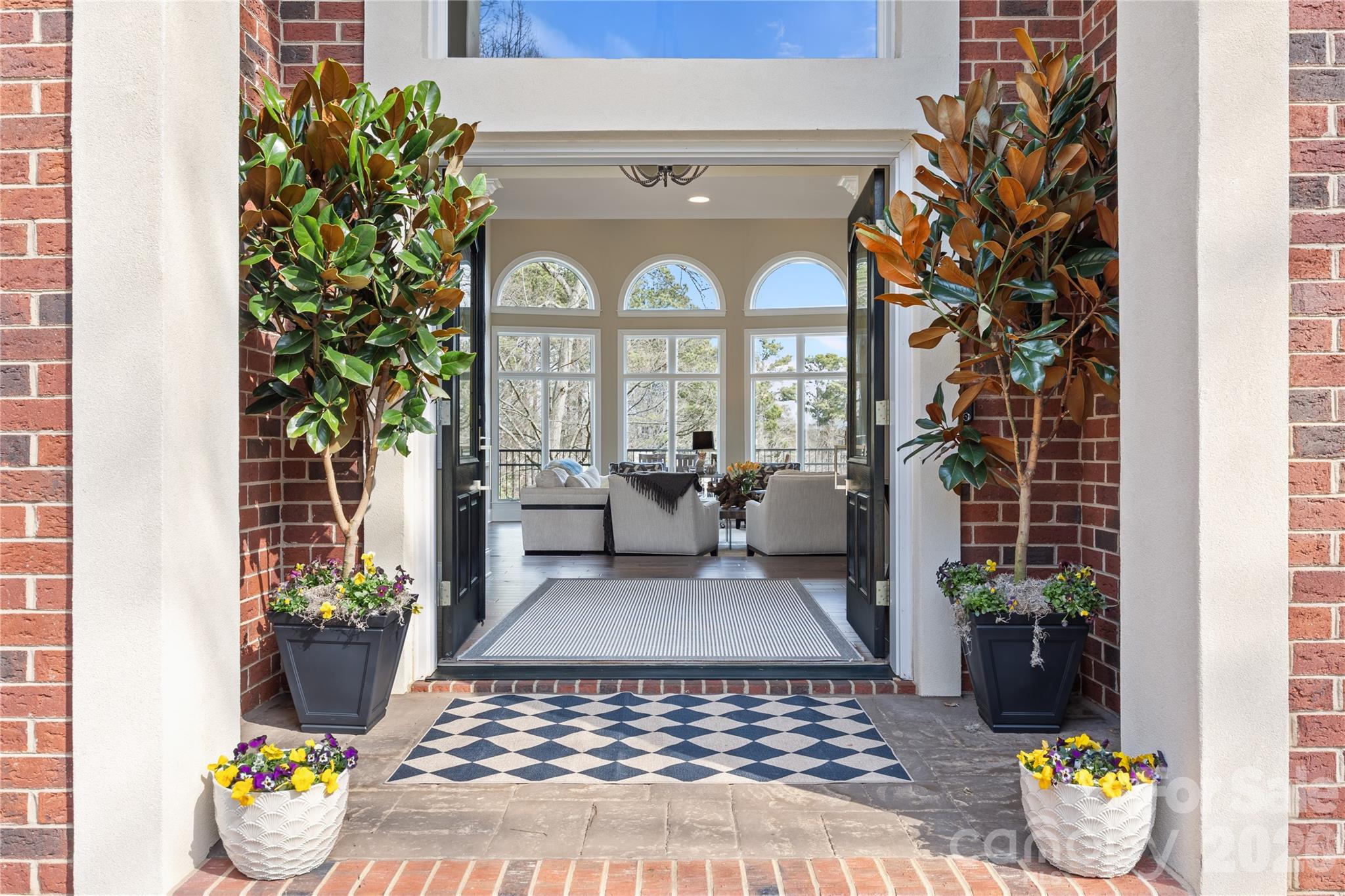 8052 Westbay Road Denver, NC 28037 - Photo 5 of 45 a view of a hallway with wooden floor and a potted plant