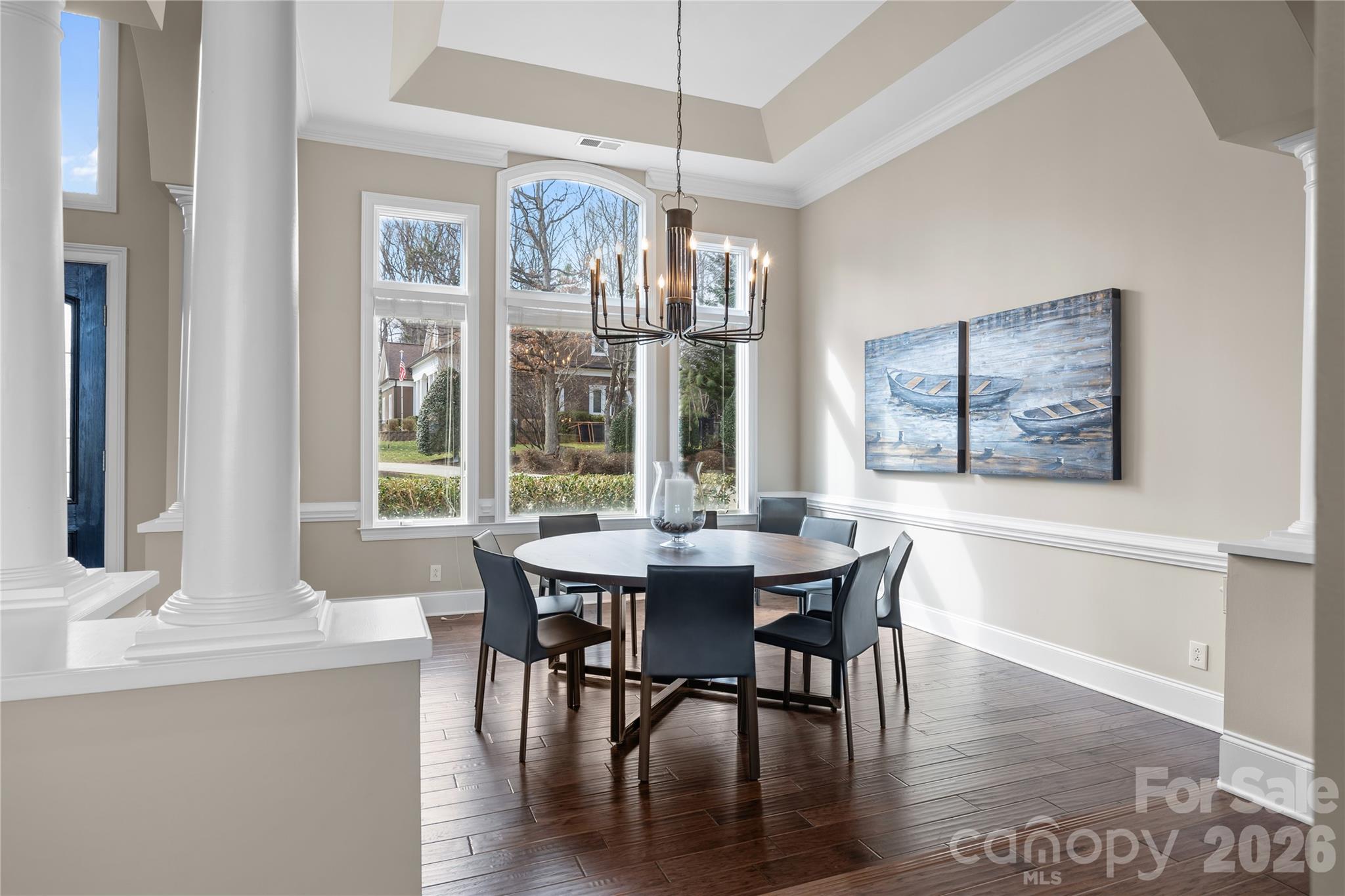 8052 Westbay Road Denver, NC 28037 - Photo 7 of 45 a dining room with furniture a chandelier and wooden floor