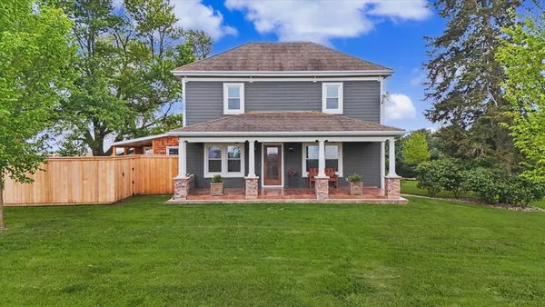 a front view of a house with a yard and porch