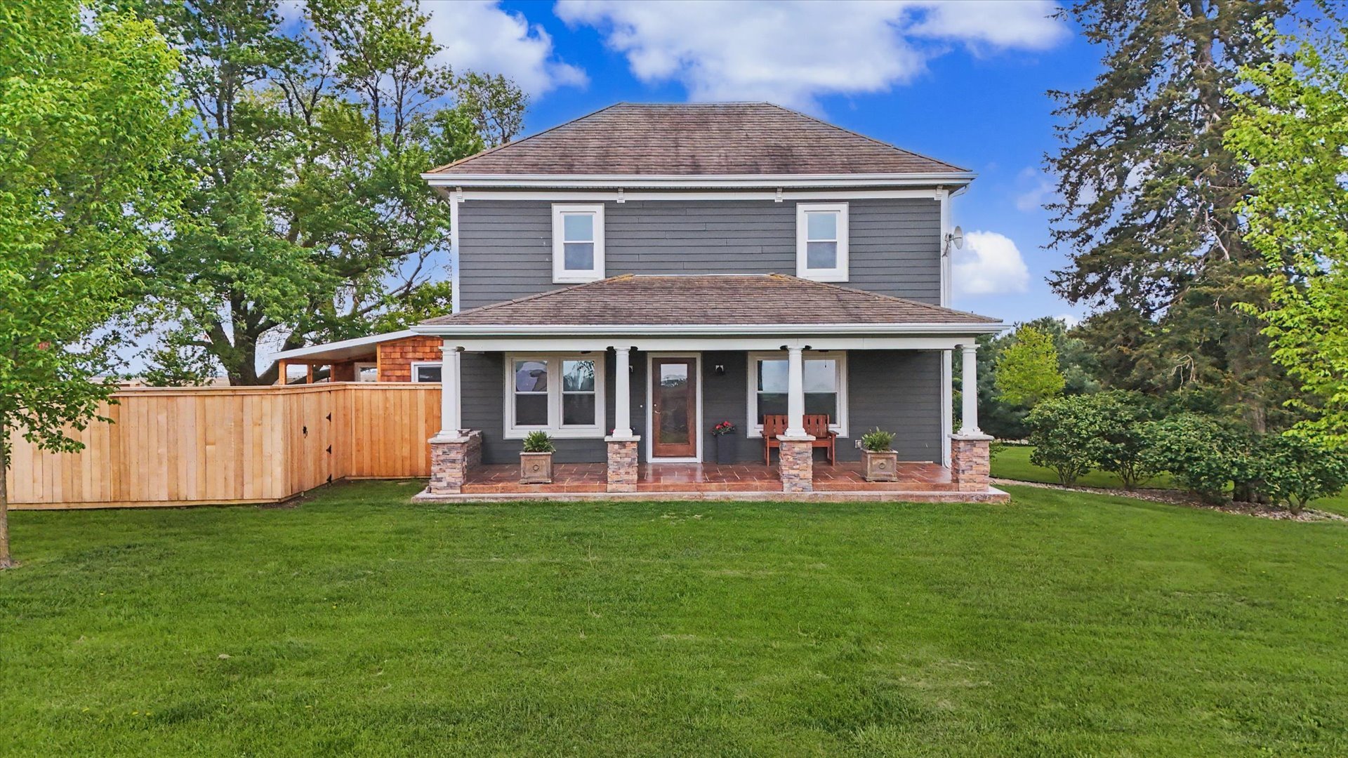 a front view of a house with a yard and porch