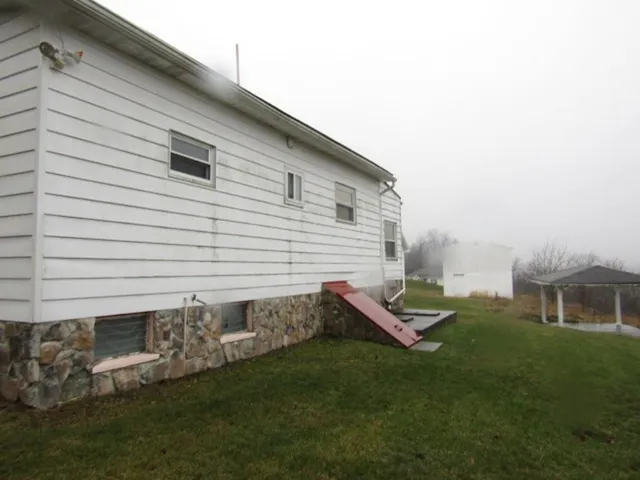 a backyard of a house with table and chairs