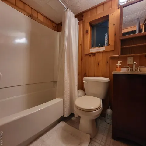 a bathroom with a toilet a sink and bathtub