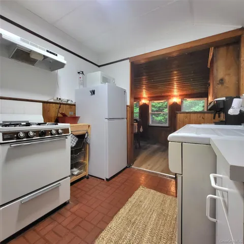 a kitchen with refrigerator and window