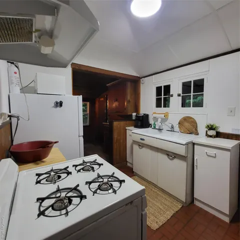 a kitchen with a sink appliances and cabinets