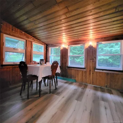 a view of a dining room with furniture window and wooden floor