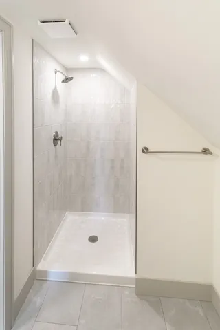 a bathroom with a shower and a bath tub