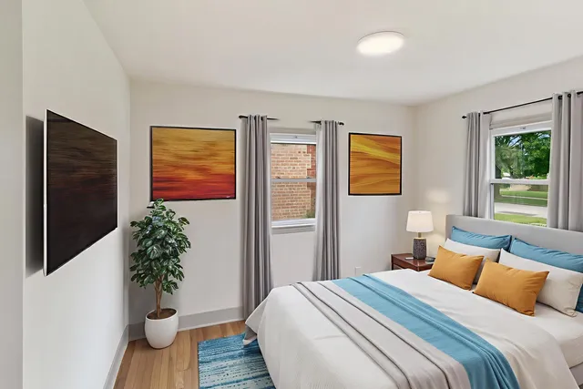 a bedroom with a bed and a potted plant