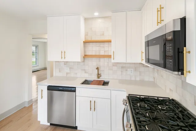 a kitchen with a sink stove and microwave