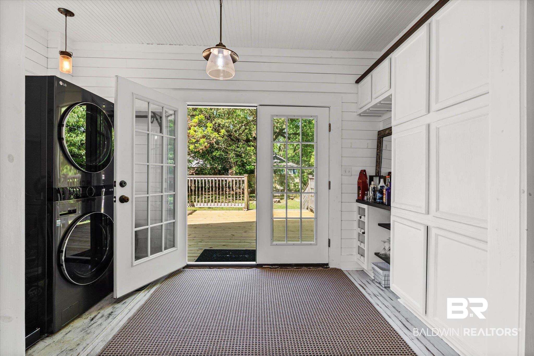 121 North Carlen Street Mobile, AL 36607 - Photo 17 of 21 Doorway to the yard featuring wooden walls and stacked washing machine and dryer