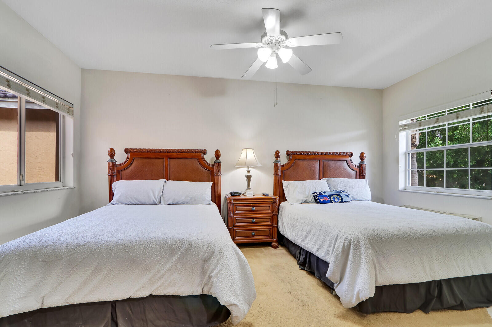 8010 Carnoustie Place, Unit 4022 Port St. Lucie, FL 34986 - Photo 5 of 7 a bedroom with two beds and a window