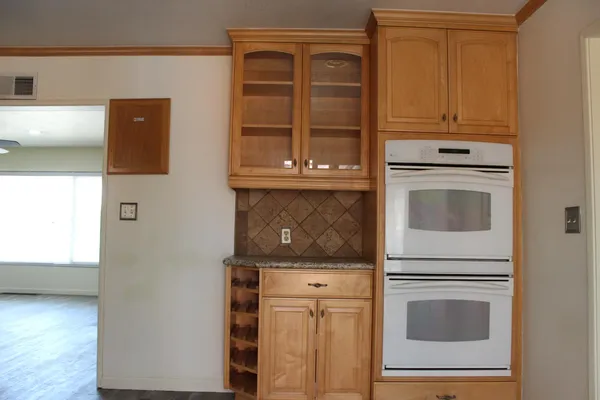 a kitchen with granite countertop cabinets stove and oven