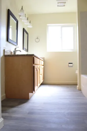 a backyard of a house with plants and wooden fence