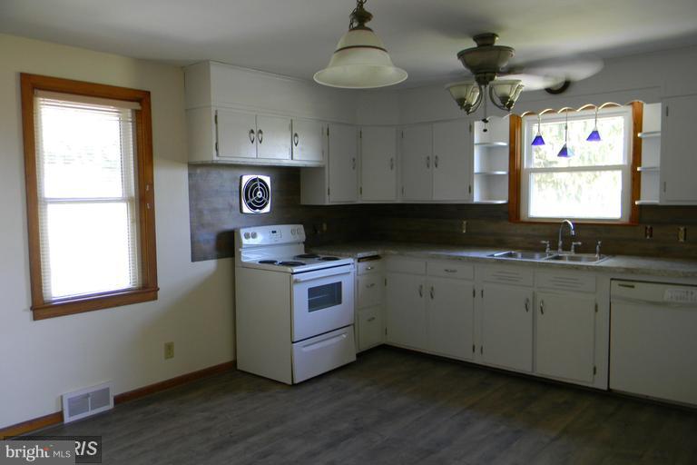 5615 Shookstown Road Frederick, MD 21702 - Photo 4 of 25 a kitchen with granite countertop white cabinets stainless steel appliances and a window