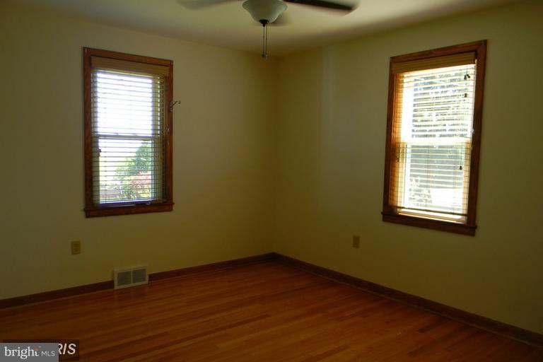 5615 Shookstown Road Frederick, MD 21702 - Photo 7 of 25 a view of an empty room with wooden floor and a window