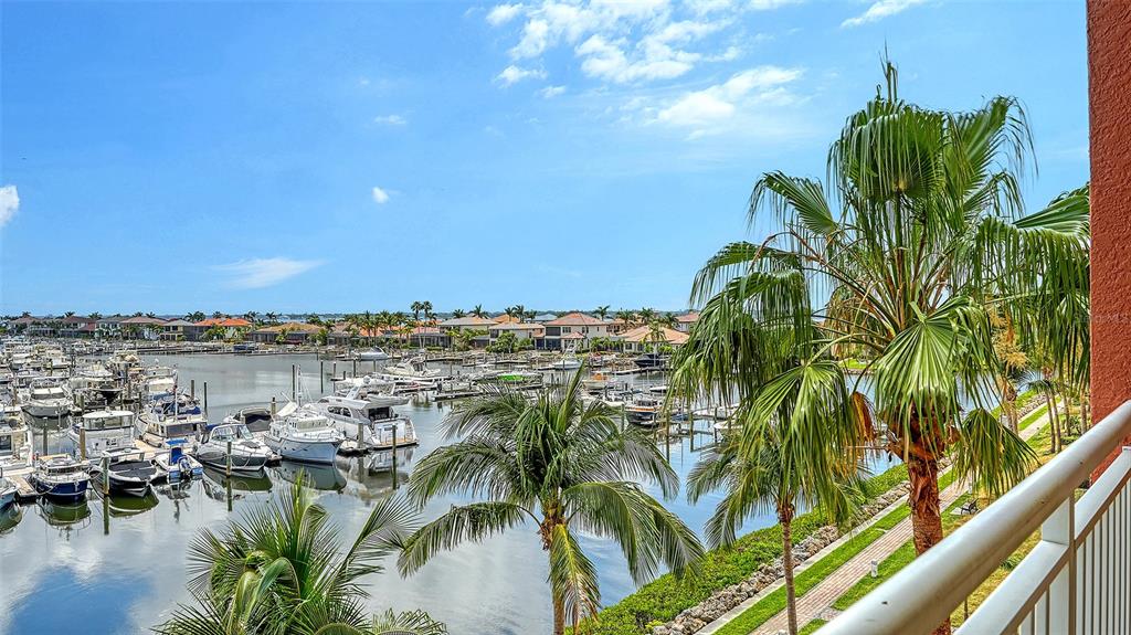 606 Riviera Dunes Way, Unit 306 Palmetto, FL 34221 - Photo 12 of 64 a view of a lake with a palm trees