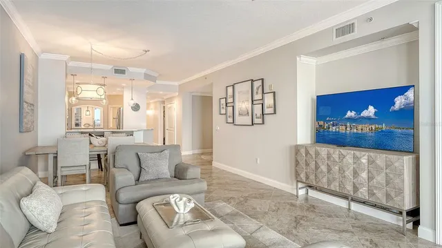 a kitchen with kitchen island stainless steel appliances a sink and a refrigerator