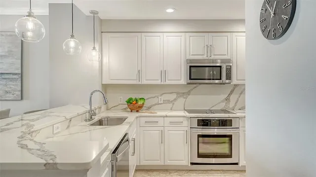 a kitchen with a sink stove and refrigerator
