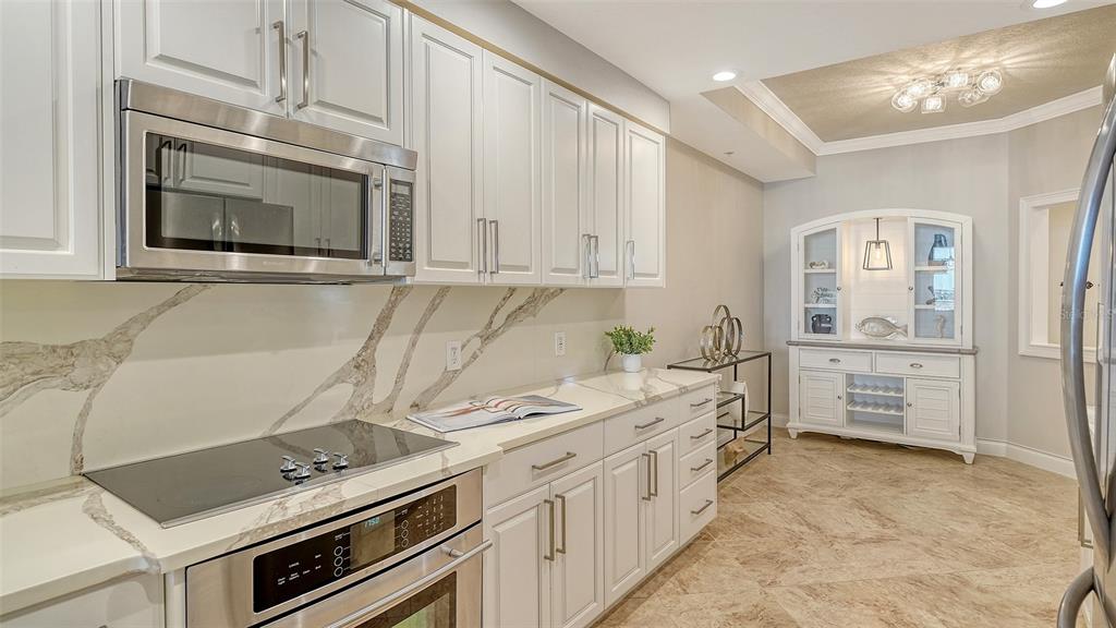 606 Riviera Dunes Way, Unit 306 Palmetto, FL 34221 - Photo 22 of 64 a kitchen with stainless steel appliances a stove sink and cabinets