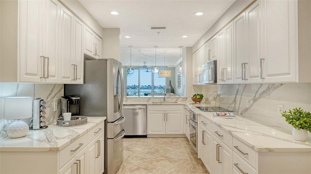 606 Riviera Dunes Way, Unit 306 Palmetto, FL 34221 - Photo 24 of 64 a kitchen with a sink stove and refrigerator