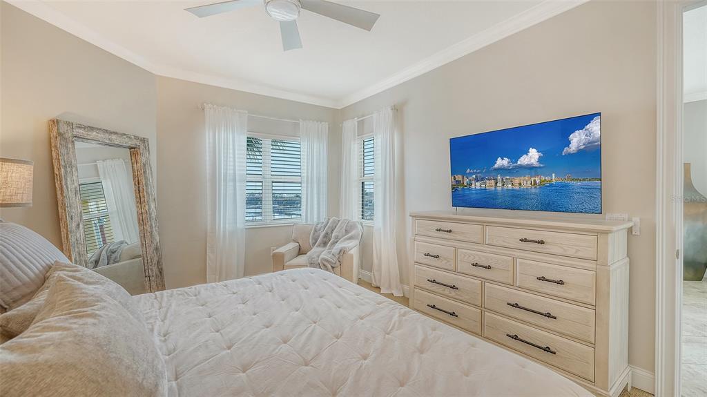 606 Riviera Dunes Way, Unit 306 Palmetto, FL 34221 - Photo 29 of 64 a bedroom with a bed and a dresser