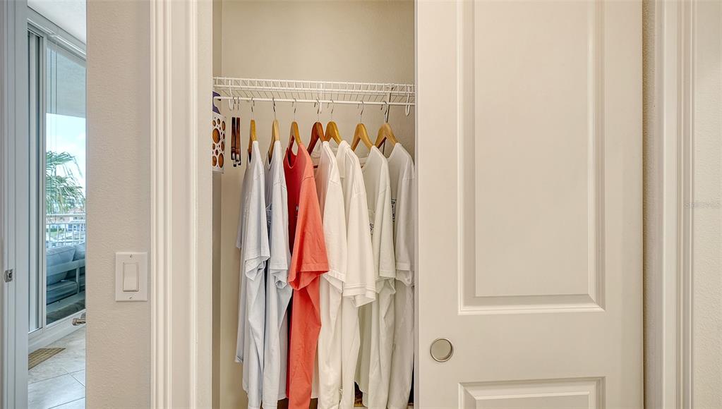 606 Riviera Dunes Way, Unit 306 Palmetto, FL 34221 - Photo 33 of 64 a view of a walk in closet with clothes