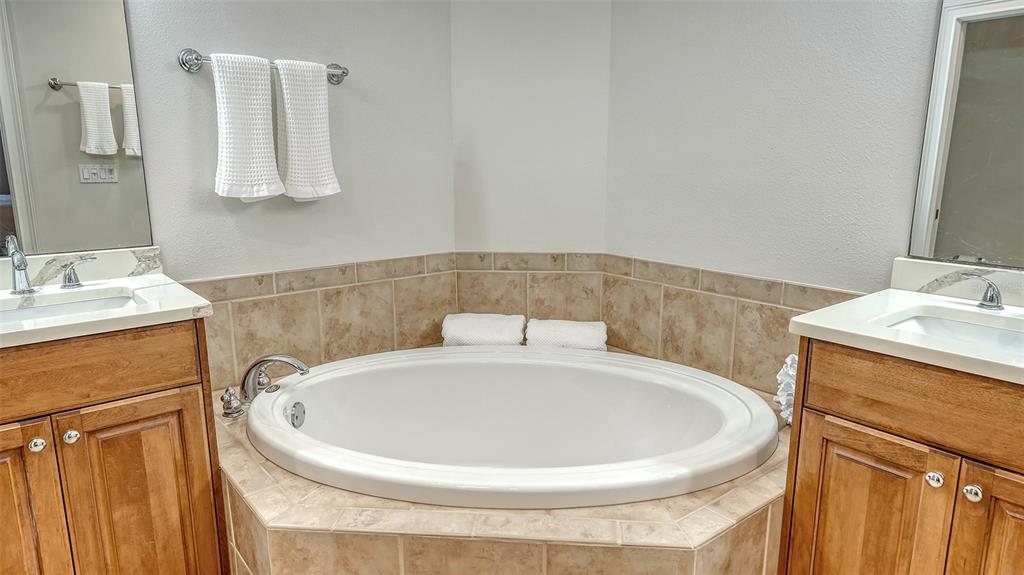 606 Riviera Dunes Way, Unit 306 Palmetto, FL 34221 - Photo 35 of 64 a bathroom with a sink and a mirror