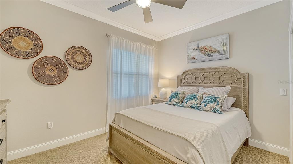 606 Riviera Dunes Way, Unit 306 Palmetto, FL 34221 - Photo 37 of 64 a bedroom with a bed and a chandelier