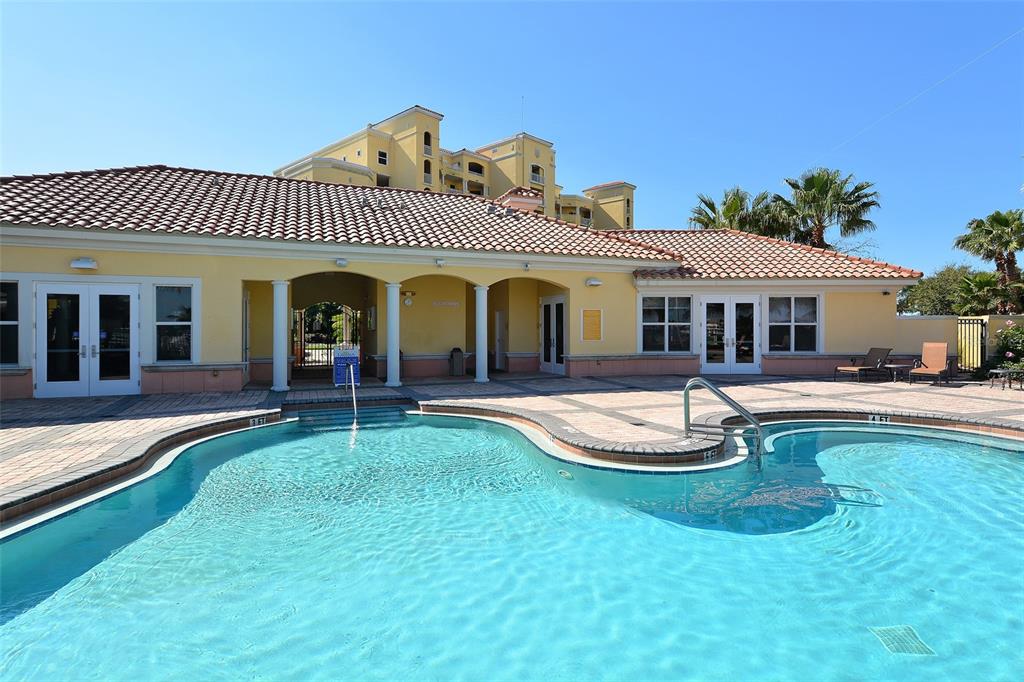 606 Riviera Dunes Way, Unit 306 Palmetto, FL 34221 - Photo 55 of 64 a front view of a house with swimming pool having outdoor seating