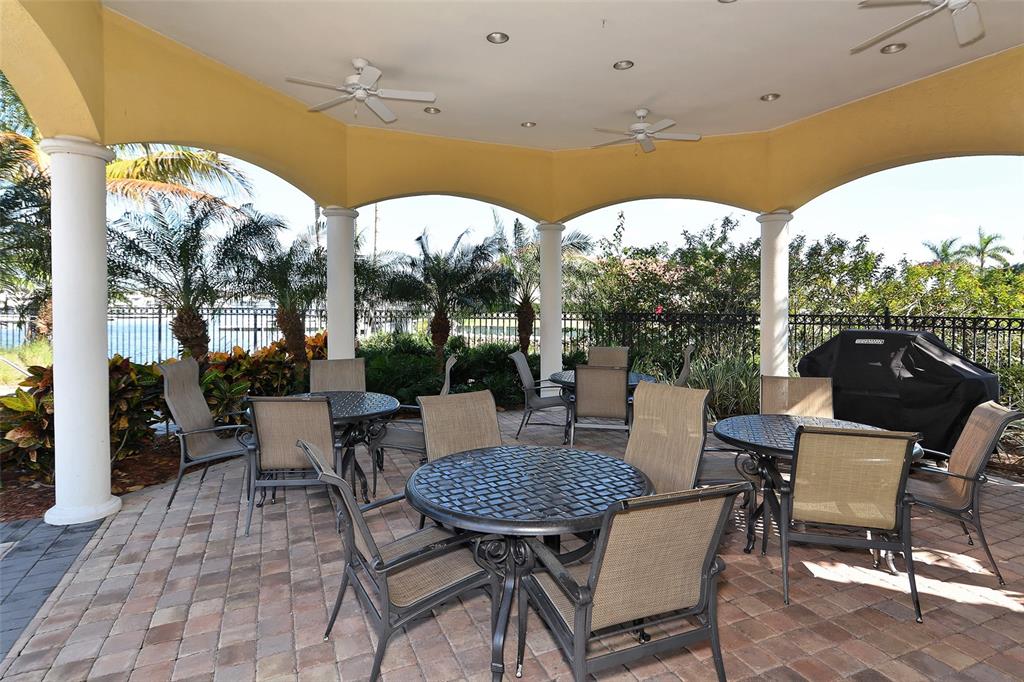 606 Riviera Dunes Way, Unit 306 Palmetto, FL 34221 - Photo 57 of 64 a view of a patio with a table and chairs