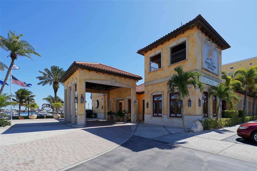 606 Riviera Dunes Way, Unit 306 Palmetto, FL 34221 - Photo 61 of 64 a front view of a house with a yard and garage