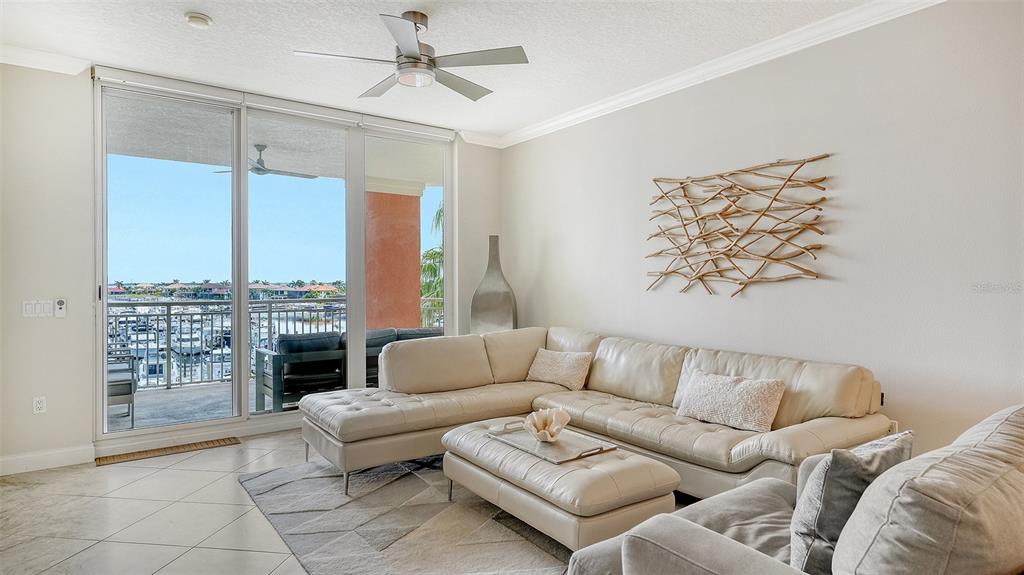 606 Riviera Dunes Way, Unit 306 Palmetto, FL 34221 - Photo 9 of 64 a living room with furniture and a fireplace