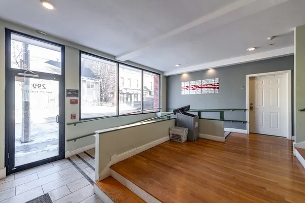 a living room with furniture and large windows