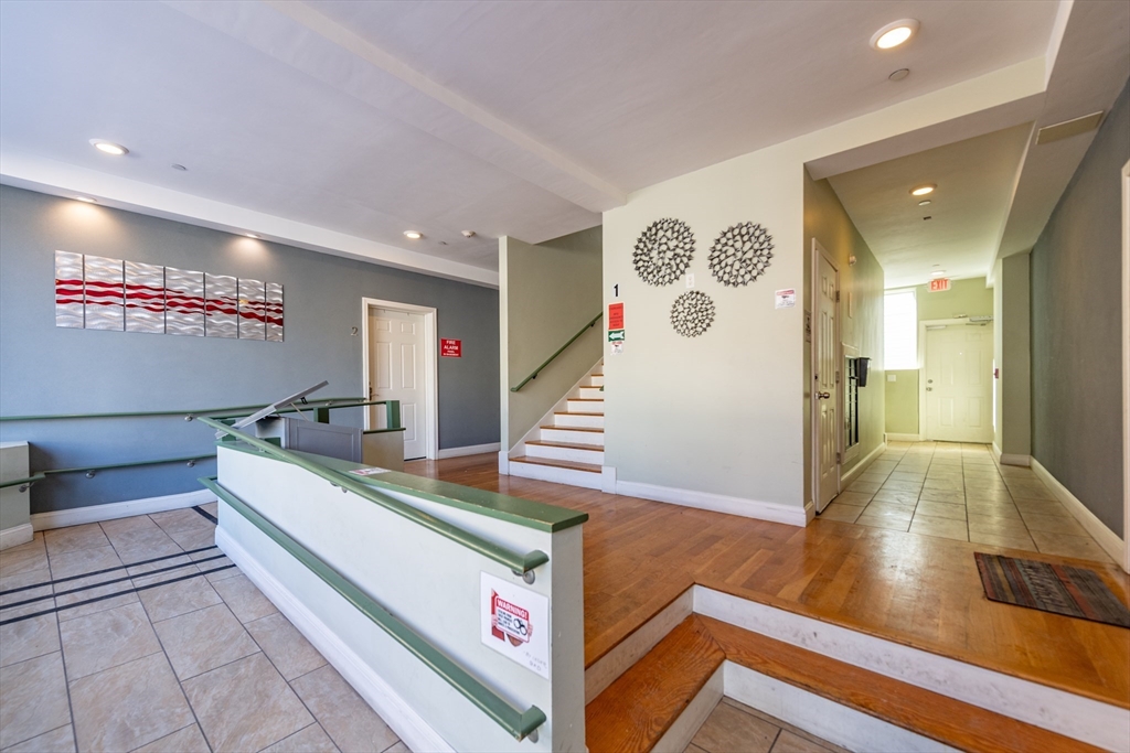 299 Dudley Street Boston, MA 02119 - Photo 4 of 18 a room with wooden floor and furniture