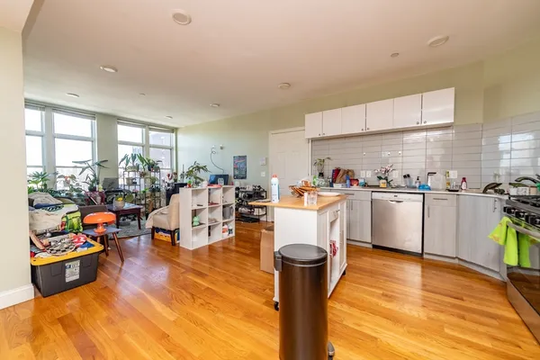 a living room with lots of furniture and kitchen view
