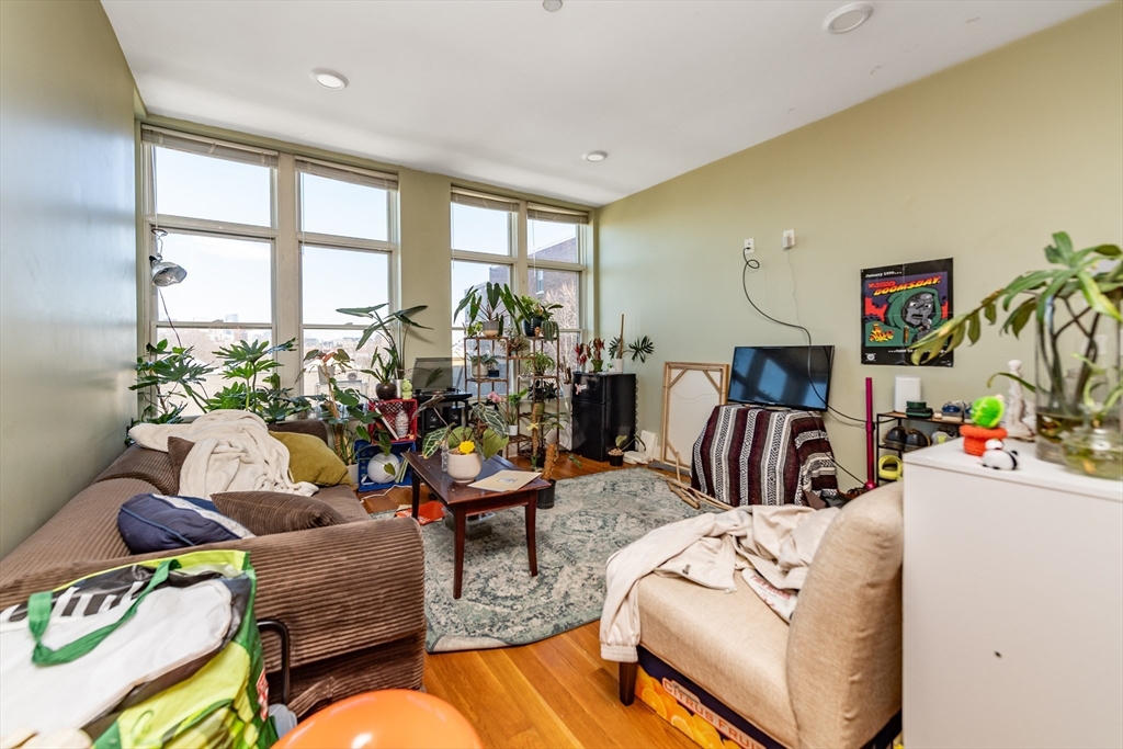 299 Dudley Street Boston, MA 02119 - Photo 9 of 18 a living room with furniture and a floor to ceiling window