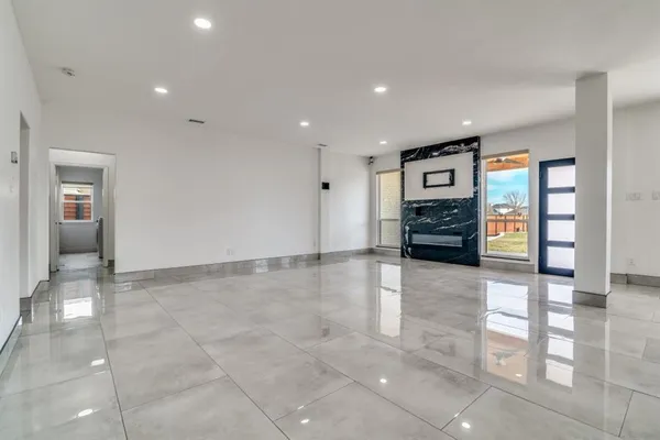 an empty room with furniture and natural light