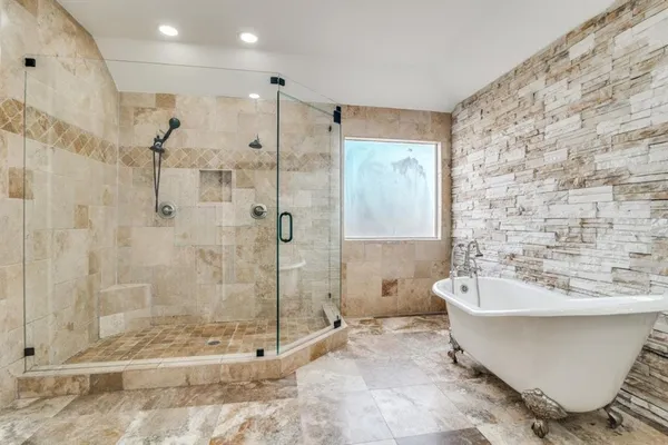 a bathroom with a bathtub and a shower