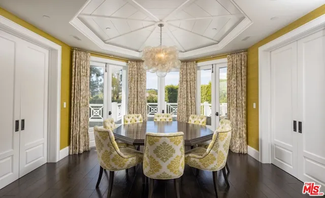 a view of a dining room with furniture wooden floor and chandelier